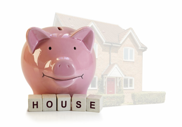 savings pig on top of blocks spelling out the word house