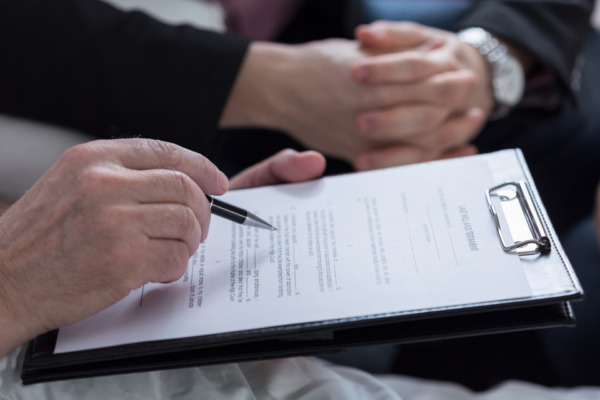 photo of person signing off after making a will in Scotland