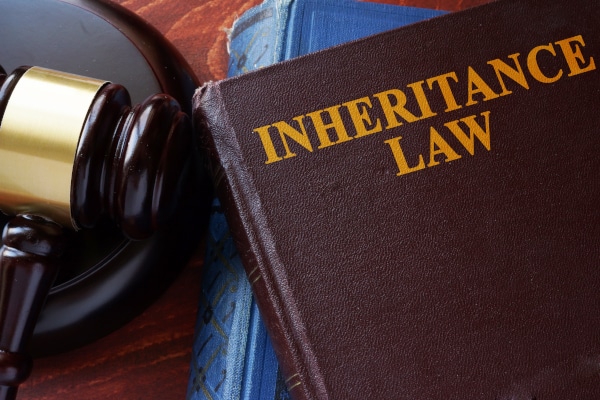 Image of a Book entitled Inheritance Law sitting on a table beside a gavel and block