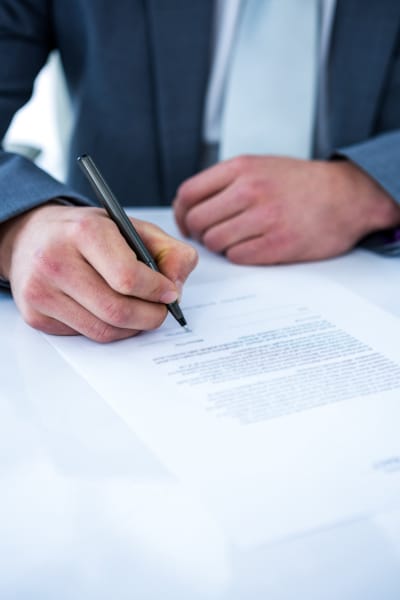 Solicitor signing an offer in the first stage of the missives process