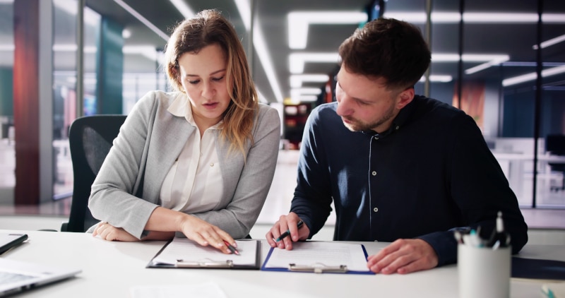 A solicitor reviews title documents at a desk during the conveyancing process for sellers in Scotland